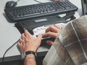 employee using braille keyboard